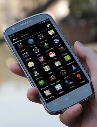 An older Android smartphone held in a hand